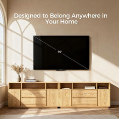 Large flat-screen TV mounted on a wall above two wooden entertainment consoles with text 'Designed to Belong Anywhere in Your Home'.