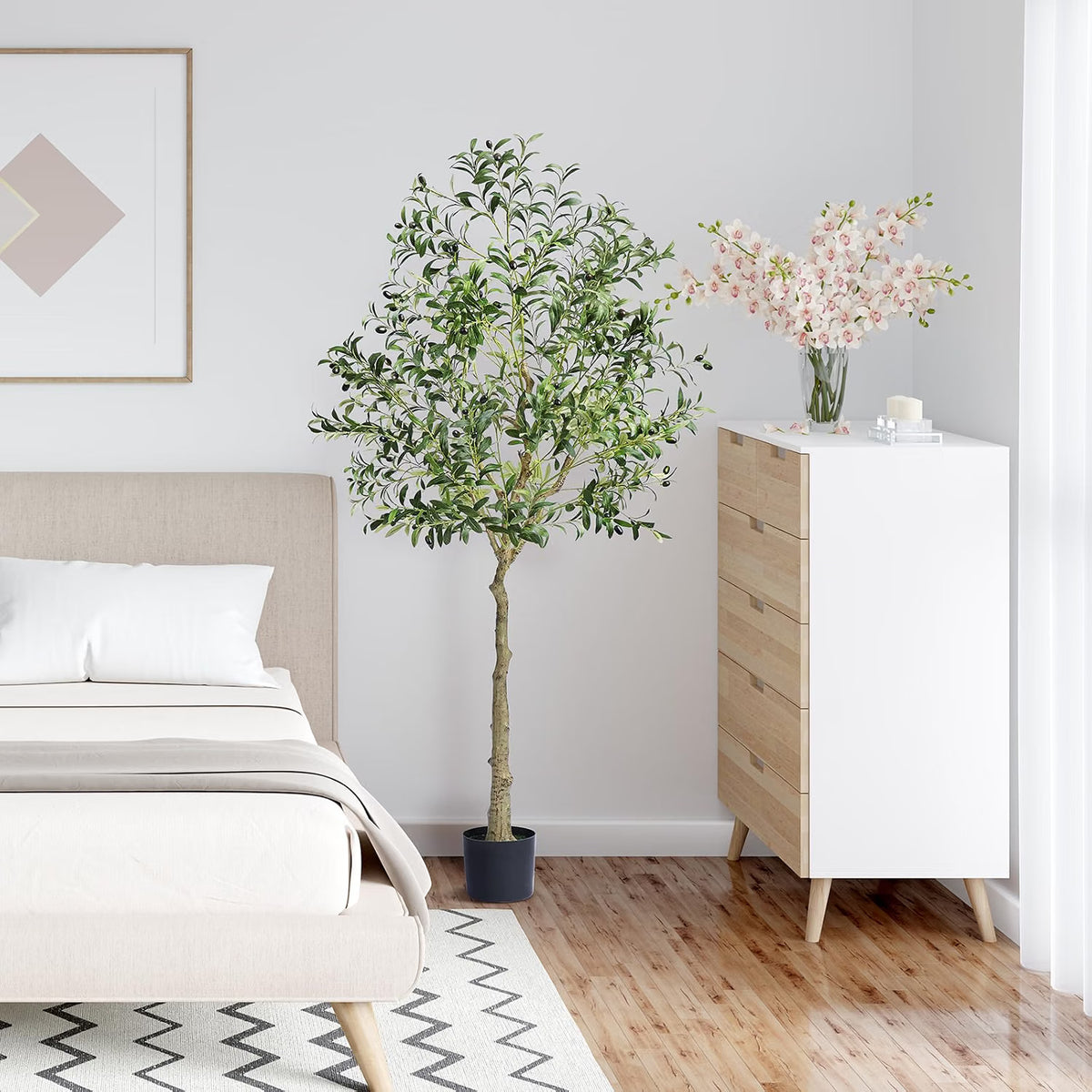 Modern bedroom with a bed, dresser, and decorative artificial olive tree plant.