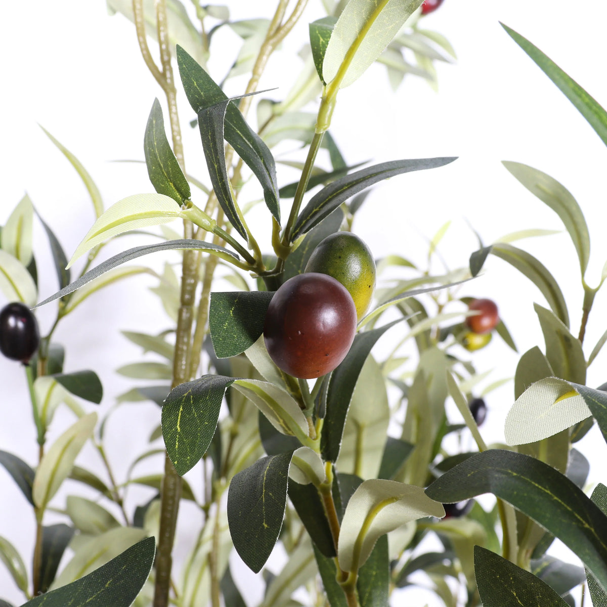 Artificial olive branch with green and black olives on a white background