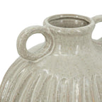 Close-up of a textured ceramic vase with two handles on a white background