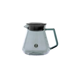 Clear glass coffee server with black lid on a white background