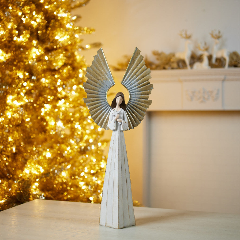 Decorative angel figurine with a gold Christmas tree in the background