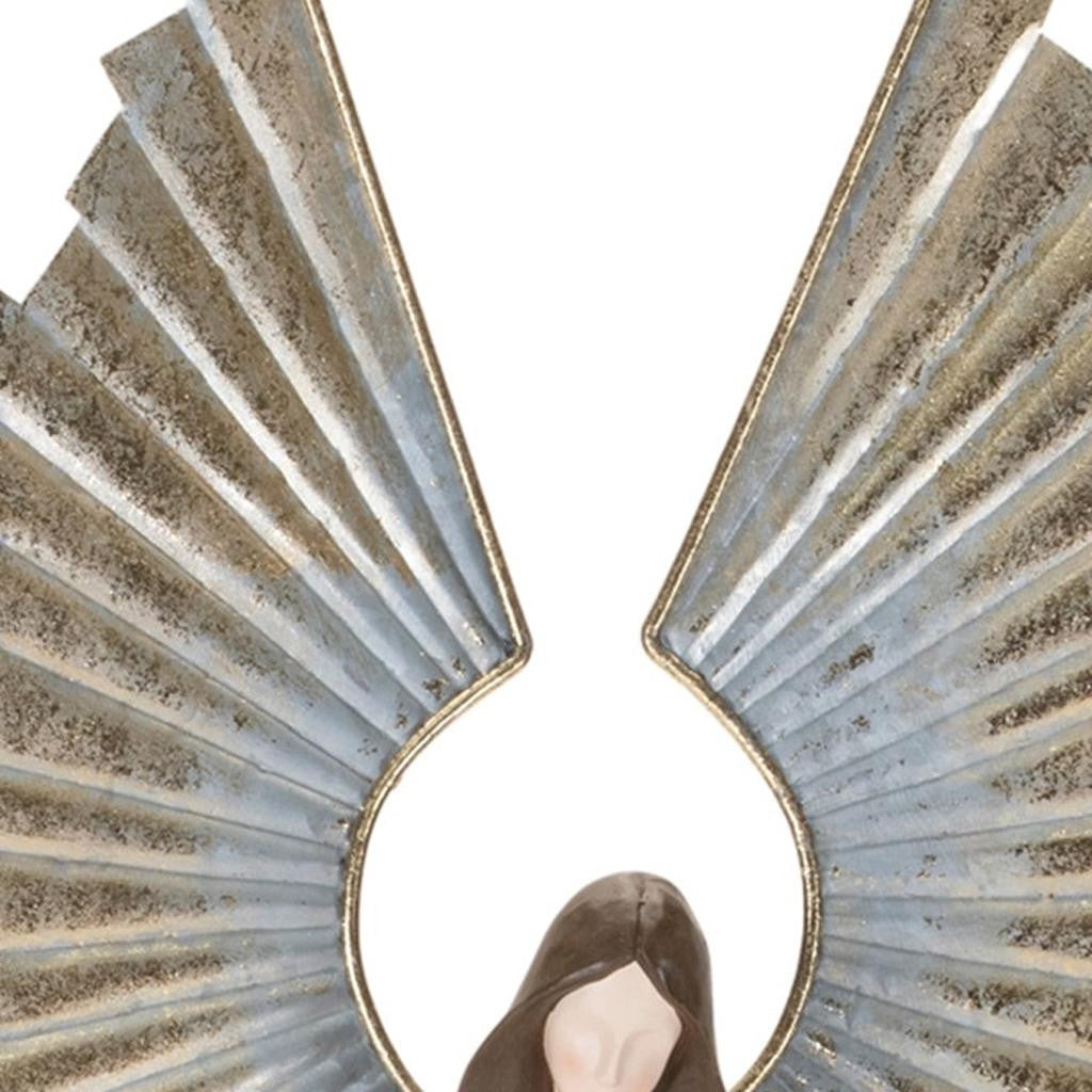 Decorative angel sculpture with metallic gold sunburst wings on a white background