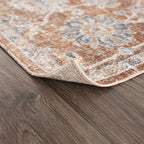 Decorative rug without rug pad shows a curled corner on a wooden floor
