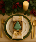 Christmas-themed table setting with a tree-shaped soap and decorative napkin.