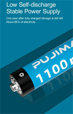 A cylindrical battery shown diagonally on a blue graphic background with marketing text at the top reading 'Low Self-discharge Stable Power Supply' and 'One year after fully charged storage is still left About 85% of electricity.' The battery has a blue body with white 'PUJIMA' branding and '1100 m' text, plus a black terminal cap with a silver screw contact.