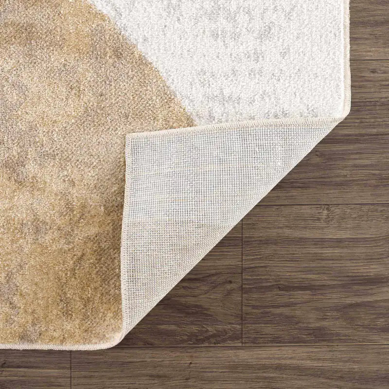 Close-up of the Giza Contemporary Washable Multicolor Rainbow Rug corner with a textured border on a wooden floor.