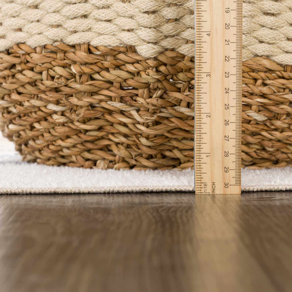 Woven basket with a ruler showing measurements of the Giza Contemporary Washable Multicolor Rainbow Rug on a wooden surface