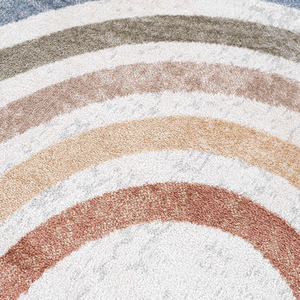 Close-up of the textured surface of the Giza Contemporary Washable Multicolor Rainbow Rug showing its circular patterns in brown, beige, and off-white.