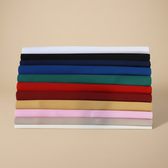 Stack of folded fabric swatches in various colors on a beige background