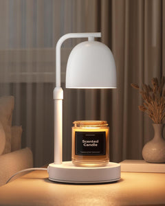 Matte white candle warmer lamp with a scented candle on a wooden surface, with a blurred background.