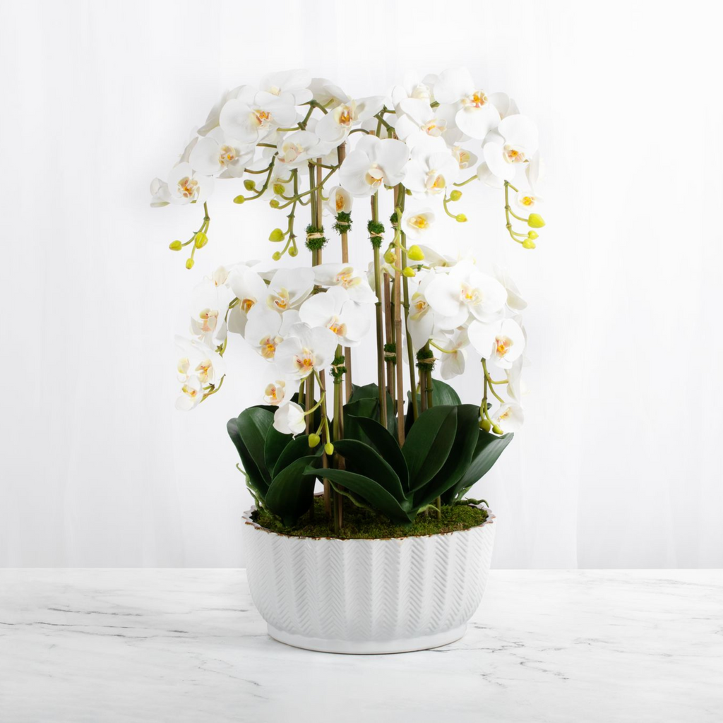 Faux orchid centerpiece in white vase-0