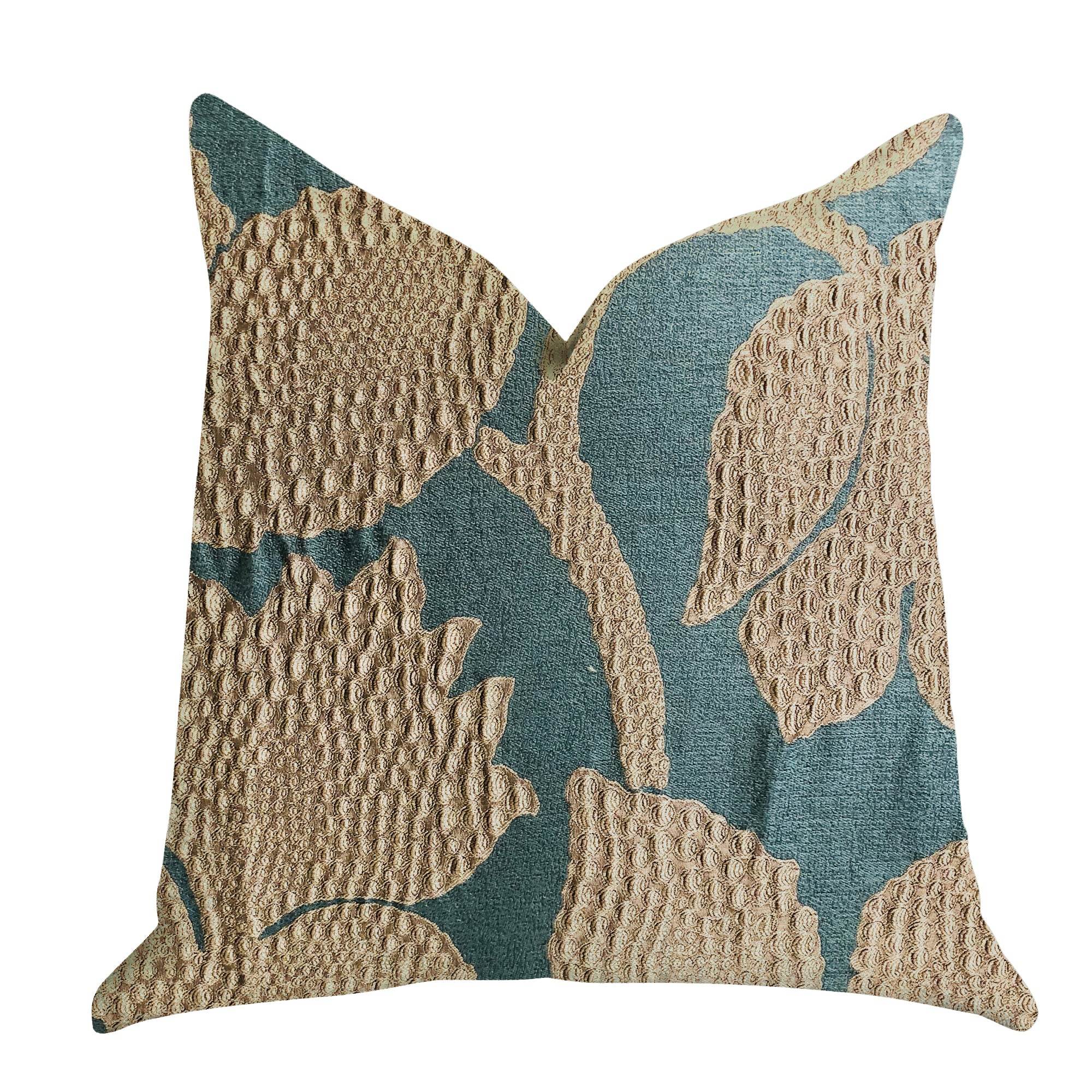 Decorative pillow with textured teal green and gold leaf pattern on a white background