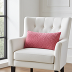 White armchair with a rose berry pillow in a bright room