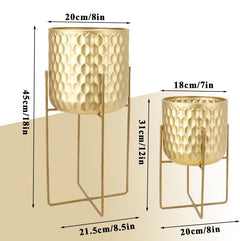 Two gold-colored hammered metal planters with matching wire stands, shown with dimension labels indicating height and width in centimeters and inches.