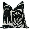 Decorative velvet pillow with black and white abstract pattern on a white background