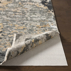 Patterned rug on a wooden floor with a protective rug pad